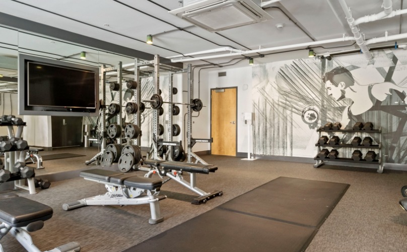 Oakland CA Apartments-MacArthur Commons Fitness Center with Cardio Machines and Stationed Bikes
