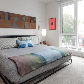 Apartments in Oakland CA-MacArthur Commons Bedroom with Large Walk In Closet Oakland Apartments - MacArthur Commons Apartments - Spacious Bedroom with Carpet Flooring and Oversized Window for Lots of Natural Light